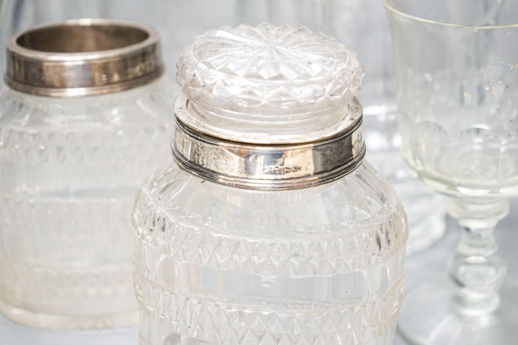 A trio of Colelfax and Fowler clear crystal candlesticks and other clear glasswares, jar height 15cm overall